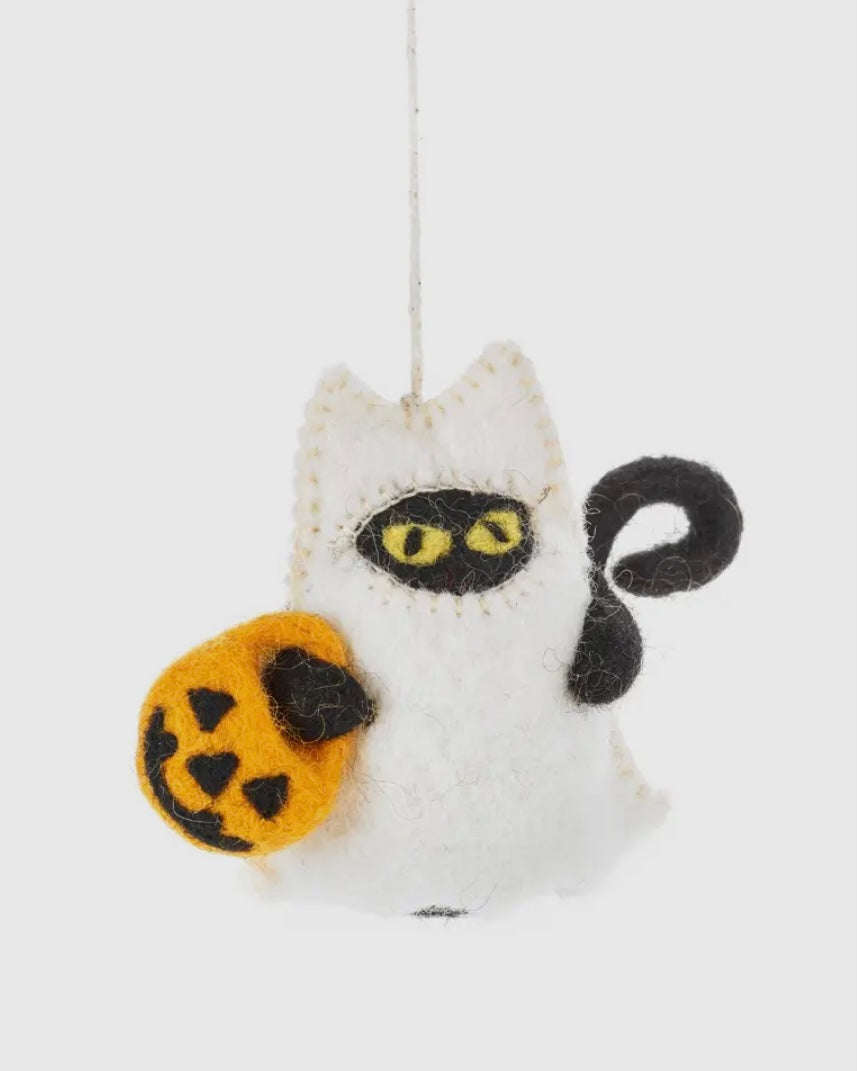 Felt hanging decoration of a cat dressed as a ghost holding a carved pumpkin bag, on a white background.