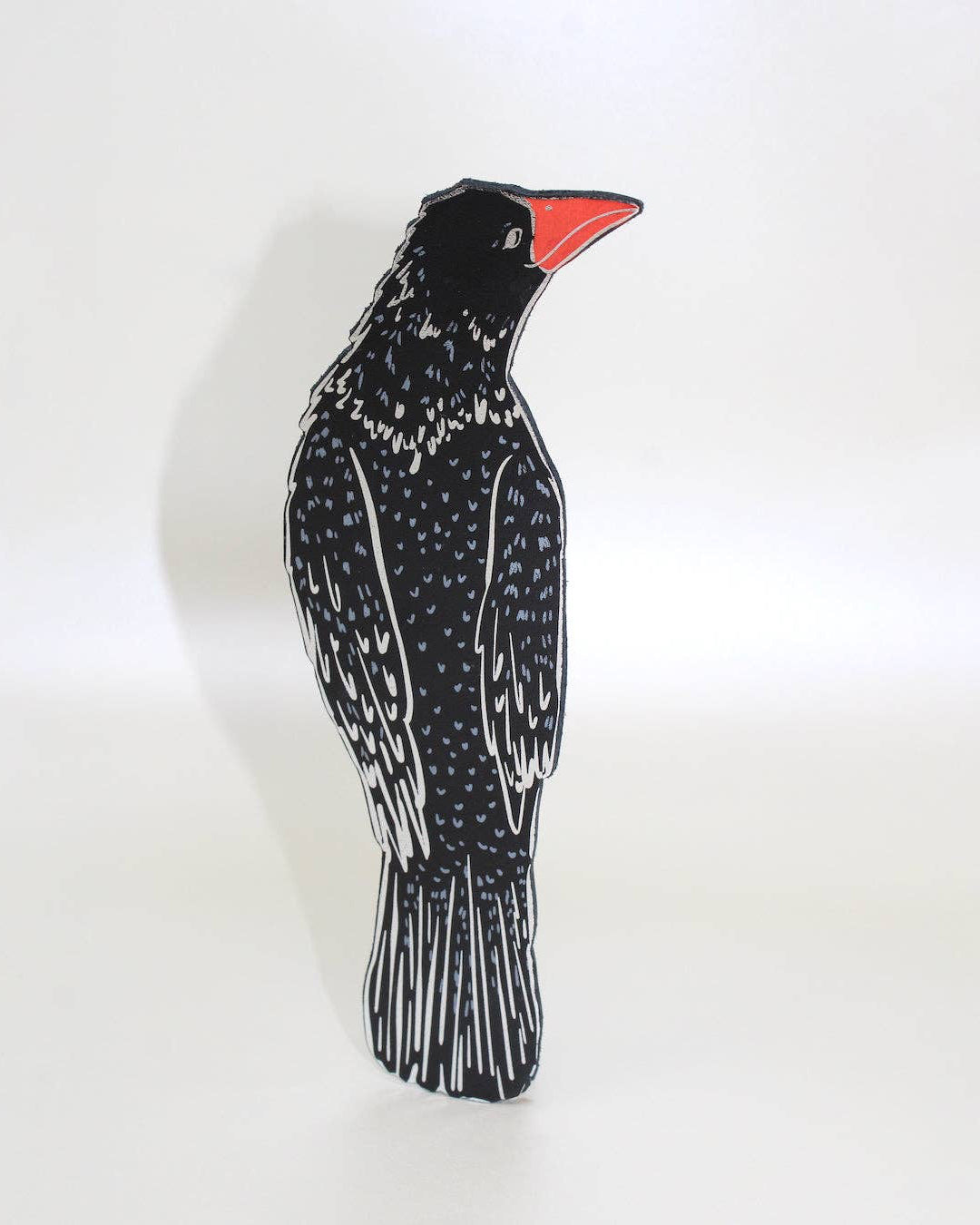 Decorative bird-shaped bookmark with black and white pattern on a white background