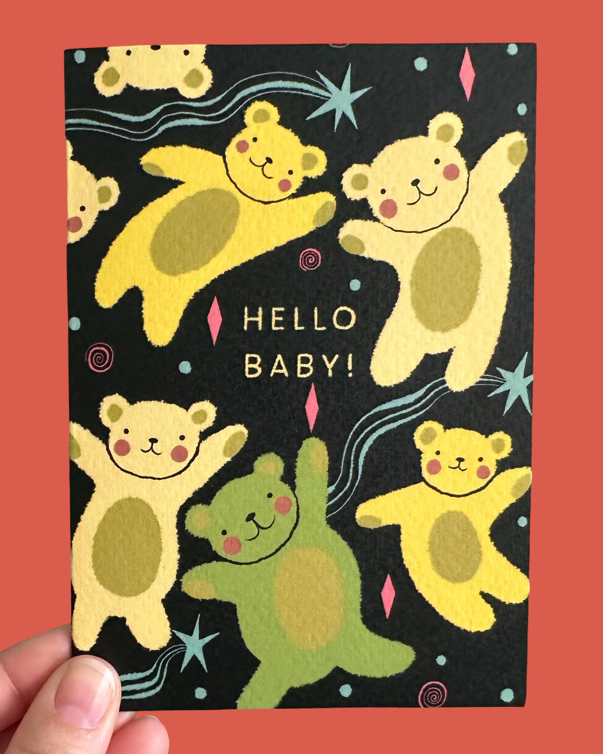 Greeting card with teddy bear illustrations and 'Hello Baby!' text on a black background.
